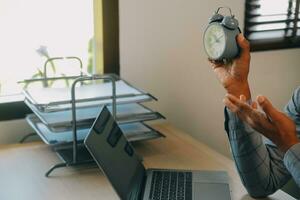 Business working times concept people work typing on laptop computer overlay with in time clock to lunch break photo