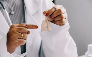 Female doctor holding virtual Lungs in hand. Handrawn human organ, copy space on right side, raw photo colors. Healthcare hospital service concept stock photo