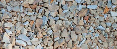 Crushed stone brown gray background texture, top view. Natural stone gravel. AI generated. photo