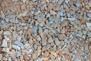 Crushed stone brown gray background texture, top view. Natural stone gravel. AI generated. photo