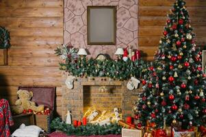 Navidad árbol cerca el hogar decorado con rojo y oro pelotas y juguetes foto