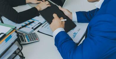 Close up of Business team analyzing income charts and graphs with modern laptop computer. Business analysis and strategy concept. photo