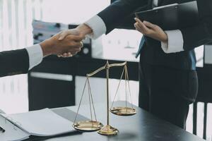 Businessman shaking hands to seal a deal with his partner lawyers or attorneys discussing a contract agreement photo