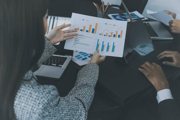 Close up of Business team analyzing income charts and graphs with modern laptop computer. Business analysis and strategy concept.