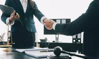 Businessman shaking hands to seal a deal with his partner lawyers or attorneys discussing a contract agreement photo