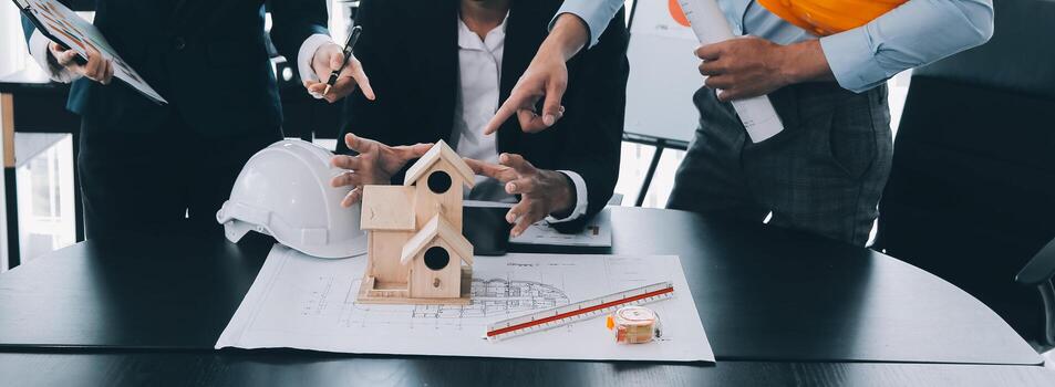 Construction and structure concept of Engineer or architect meeting for project working with partner and engineering tools on model building and blueprint in working site, contract for both companies. photo