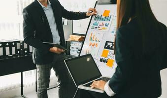 Business team working with new startup project plan and discussion information for financial strategy with laptop and digital tablet in a modern business lounge. photo