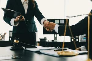 Businessman shaking hands to seal a deal with his partner lawyers or attorneys discussing a contract agreement photo