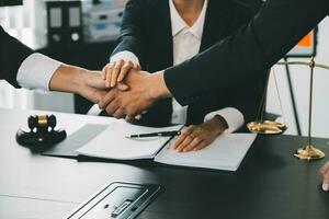 Businessman shaking hands to seal a deal with his partner lawyers or attorneys discussing a contract agreement photo