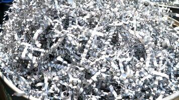 Steel scrap materials recycling. Aluminum chip waste after machining metal parts on a cnc lathe. Closeup twisted spiral steel shavings. Small roughness sharpness, video