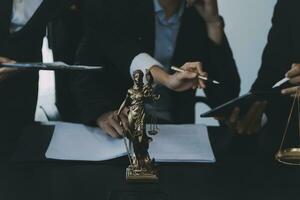 Business and lawyers discussing contract papers with brass scale on desk in office. Law, legal services, advice, justice and law concept picture with film grain effect photo