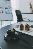 Business and lawyers discussing contract papers with brass scale on desk in office. Law, legal services, advice, justice and law concept picture with film grain effect photo