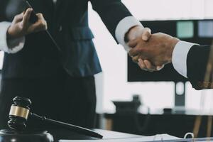 Businessman shaking hands to seal a deal with his partner lawyers or attorneys discussing a contract agreement photo