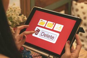 Deleting documents, junk mail, electronic messages or personal information in tablet system. Concepts of technology and document management from online platforms photo