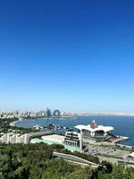 View from mountain to sea. Seashore. Baku, Azerbaijan. Mall. Pineapple-shaped building. View from hill. Mountain landscape, sea in distance. Beautiful natural view and famous building. Vertical photo