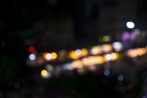 Night city street abstract blurry bokeh lights background photo