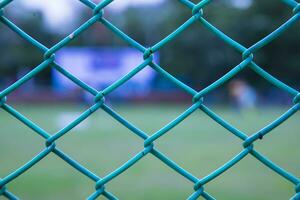 Wire Fence Mesh Pattern Abstract Background of The Close-Up Shot in Soccer Field photo