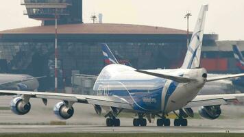 MOSCOW, RUSSIAN FEDERATION JULY 30, 2021 Footage of Boeing 747 on the taxiway or runway. Huge cargo jumbo jet of AirBridgeCargo taxiing, rear view video