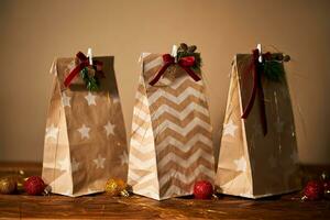 Christmas gift bags with decor and Christmas ornament. photo