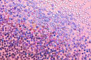 Purple sparkles on a pink background. photo