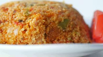 bulgur rice with tomato on a plate , video