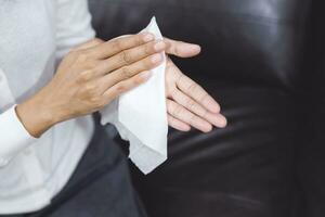 woman using tissue paper Clean your hands to remove germs. photo