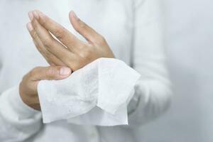 woman using tissue paper Clean your hands to remove germs. photo