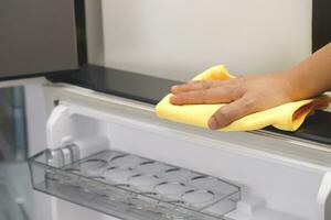 Employees use a cloth to clean the refrigerator. photo