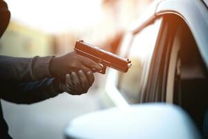 Thieves are using guns to rob a car, threatening a woman with car keys photo