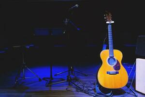 Guitar and band on concert stage photo