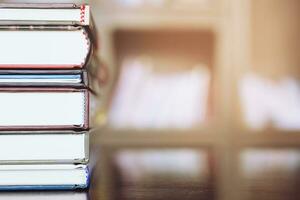 Book stack in the library room and blurred bookshelf for business and education photo