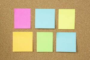 collection of colorful variety post it. paper note reminder sticky notes pin paper blue  on cork bulletin board. empty space for text photo