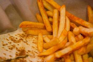 French fries with ketchup,chili sauce,mayonnaise,wasabi on wooden background, top view photo