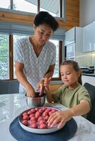 Grandmother and granddaughter preparing meatballs. photo