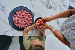 Grandmother and granddaughter preparing meatballs. photo