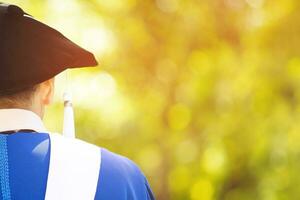 Graduates with diplomas in their hands hugging photo