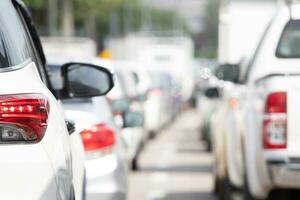 Car rush hours city street. Cars on highway in traffic jam photo