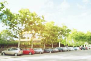 photo blurred aerial car parking lot outdoors Square, cars in row Parking on the side of the road and evening sun. Leave space empty for text.