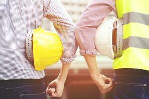 Construction engineers discussion with architects at construction site or building site of highrise building photo