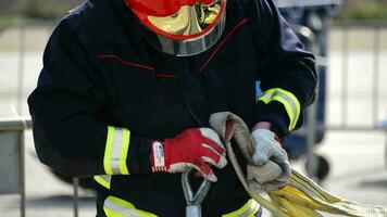 Firefighter working with ropes in rescue simulation of a traffic accident video