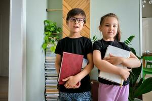 A boy and a girl with books in their hands. photo