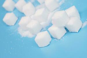 background of sugar cubes. Sugar with copy space. White sugar on turquoise blue background. soft focus photo