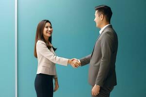 Asian young woman shaking hands with businessman photo