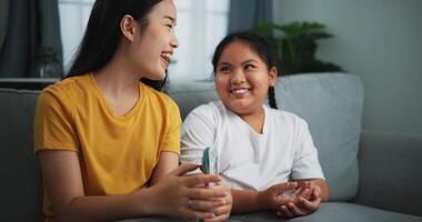 Portrait of young women and teen girl counting cash money on sofa in the living room at home,Happy counting dollars banknote. photo