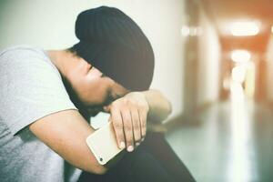 depressed man bent head in hands go with floor. dramatic concept photo