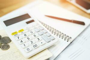 Office desk table calculator with  notepad book  and black pen. Top view with copy space. investment calculation Accounting, financial concept photo