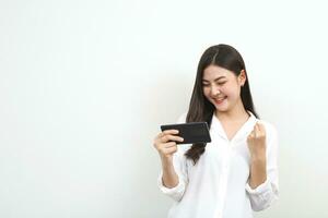 Model asian woman emotion happy and excited to win prizes with online lottery tickets on their mobile phones. photo