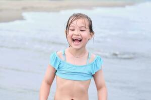 The girl laughs sincerely after swimming. photo