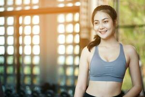 Asian woman exercising to lose weight at the gym photo