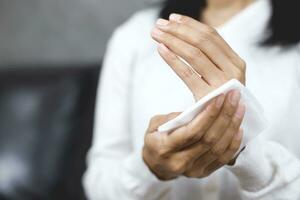 woman using tissue paper Clean your hands to remove germs. photo